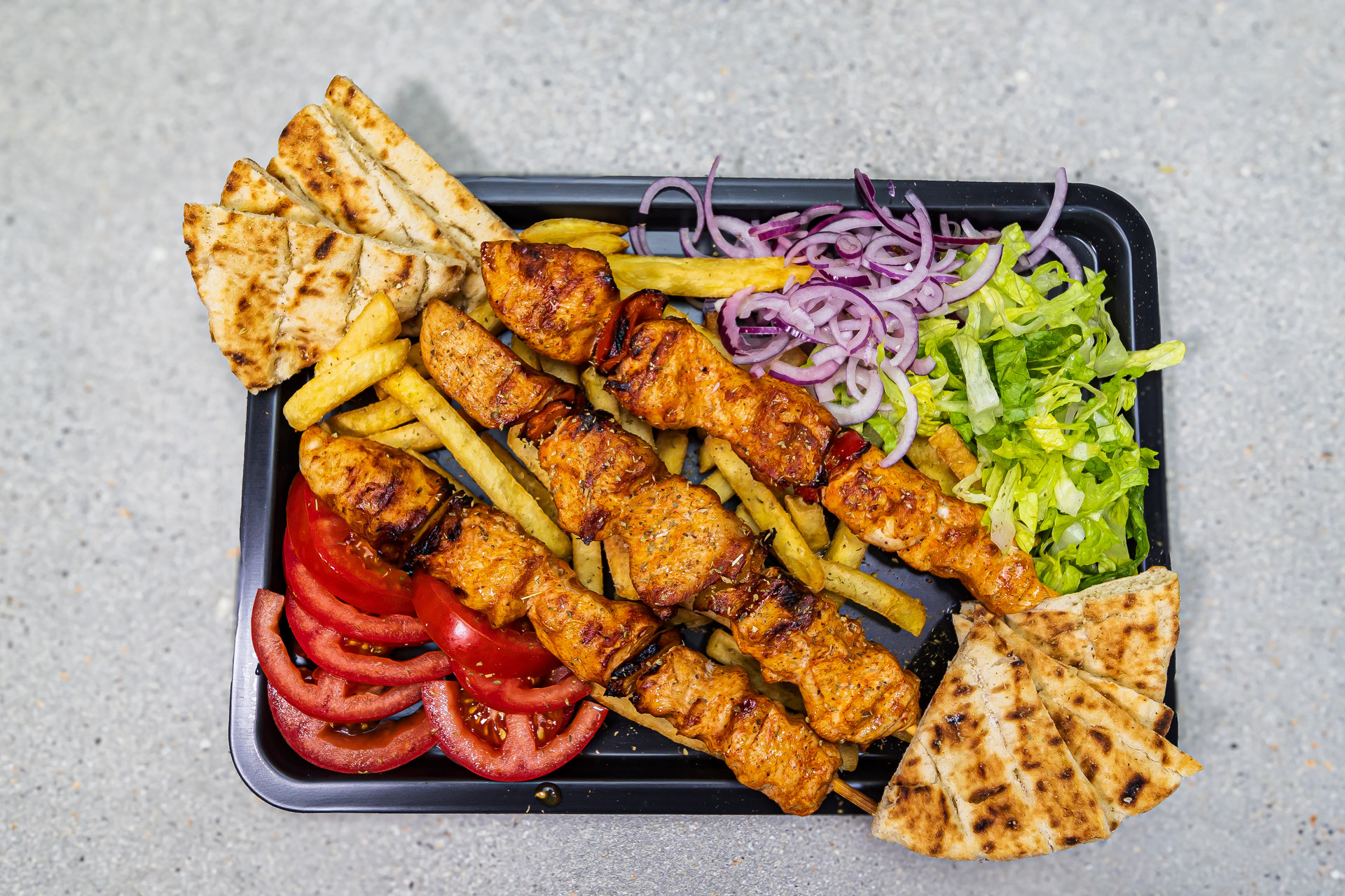 3 chicken souvlaki skewers served with pitta bread, french fries and homemade tzatziki - Cristinas Greek Souvlaki Daventry